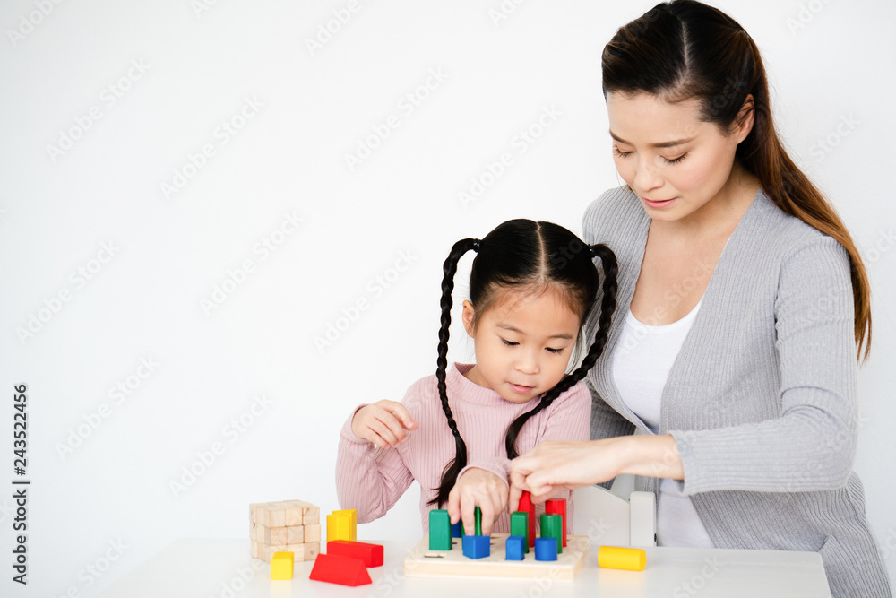 Asian mom are doing activities with their daughters. playing a lot of colored sticks which is good learning development for children Making artistic imagination And control emotions for as thinkers Asian mom are doing activities with their daughters. playing a lot of colored sticks which is good learning development for children Making artistic imagination And control emotions for as thinkers