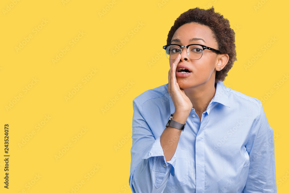 Young beautiful african american business woman over isolated background hand on mouth telling secret rumor, whispering malicious talk conversation Young beautiful african american business woman over isolated background hand on mouth telling secret rumor, whispering malicious talk conversation