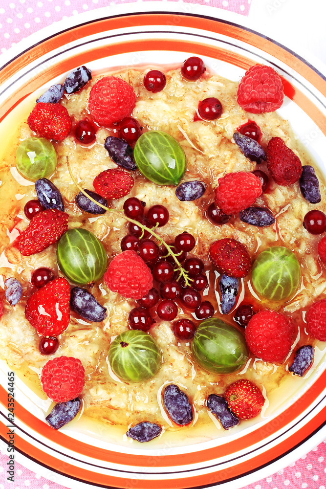 breakfast oatmeal with berries and honey on white wooden background flat style top view overhead summer menu breakfast oatmeal with berries and honey on white wooden background flat style top view overhead summer menu