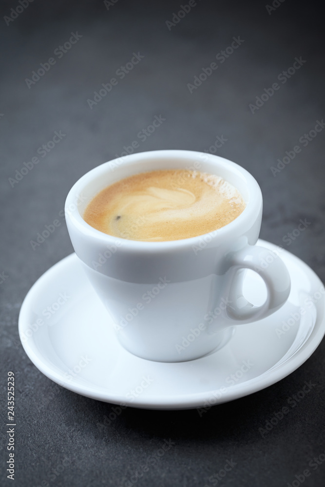 Cup of coffee on black stone background. Close up. Cup of coffee on black stone background. Close up.