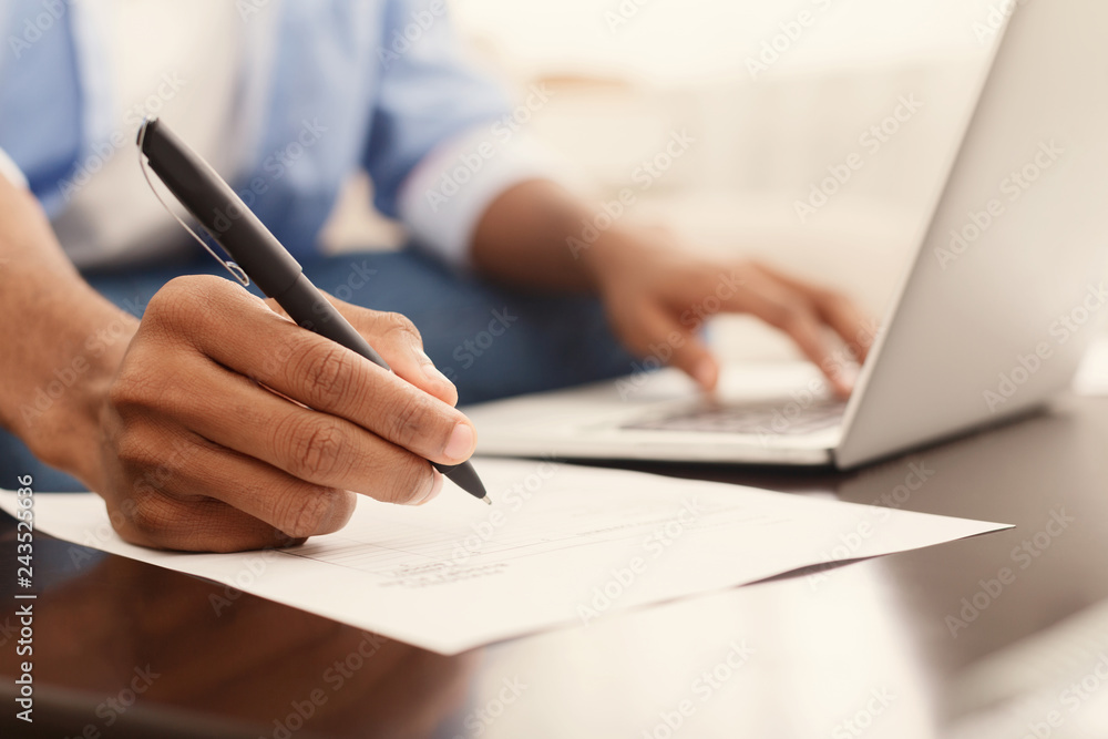 Financier making annual financial report using laptop Financier making annual financial report using laptop