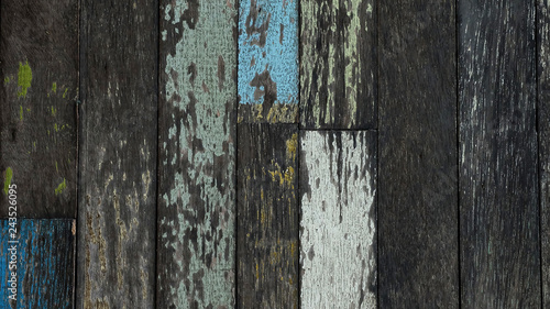 Texture or background of yellow, green and blue pained and plain wood wall, economic design from reusing the old wood, value added tactics for making more money and creating unique fashionable style