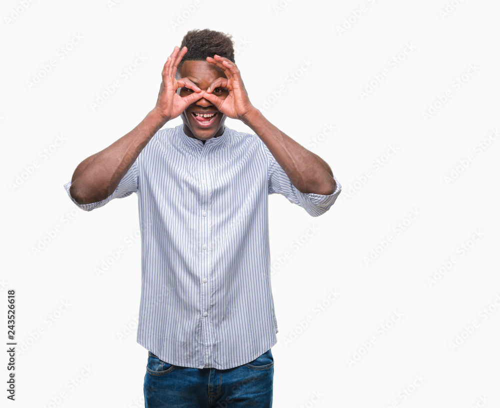 Young african american man over isolated background doing ok gesture like binoculars sticking tongue out, eyes looking through fingers. Crazy expression. Young african american man over isolated background doing ok gesture like binoculars sticking tongue out, eyes looking through fingers. Crazy expression.