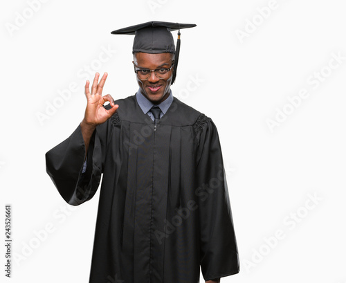 Young graduated african american man over isolated background smiling positive doing ok sign with hand and fingers. Successful expression.