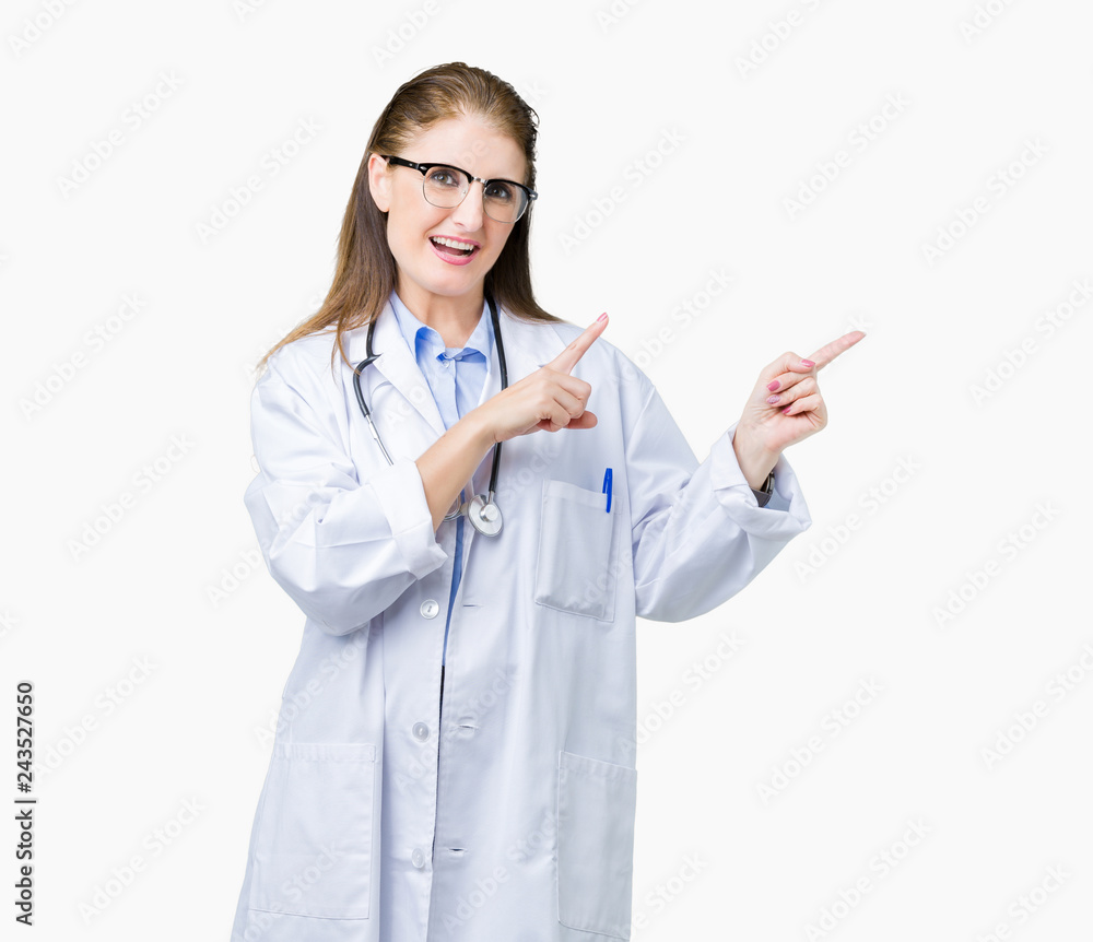 Middle age mature doctor woman wearing medical coat over isolated background smiling and looking at the camera pointing with two hands and fingers to the side. Middle age mature doctor woman wearing medical coat over isolated background smiling and looking at the camera pointing with two hands and fingers to the side.