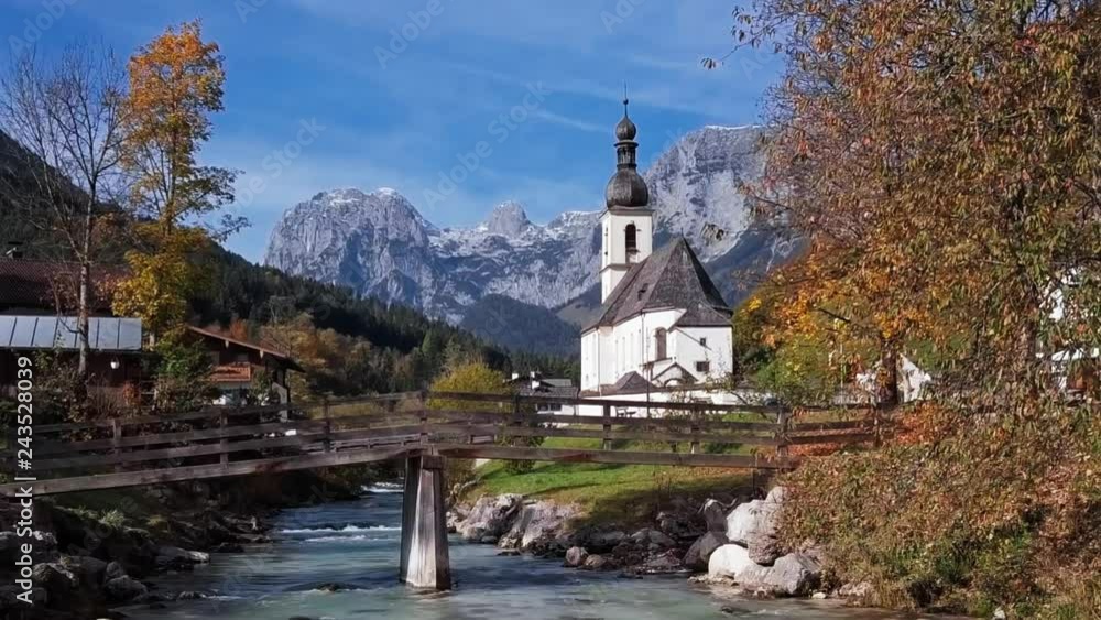 Flight over footbridge near famous Parish church St. Sebastian, in Ramsau, Berchtesgaden, Bavarian Alps Germany. Flight over footbridge near famous Parish church St. Sebastian, in Ramsau, Berchtesgaden, Bavarian Alps Germany.