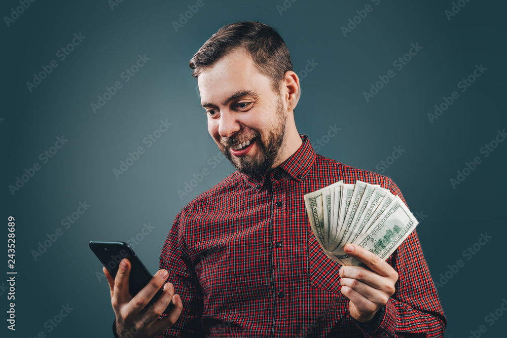 Man celebrating victory after making bets at bookmaker website - obrazy, fototapety, plakaty 