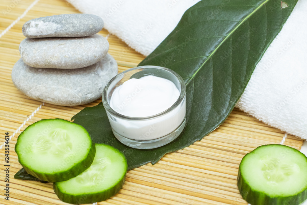 Natural Skin Care Products. View ingredients on table concept of the best all natural face moisturizer. Spa stone and white towel Natural Skin Care Products. View ingredients on table concept of the best all natural face moisturizer. Spa stone and white towel