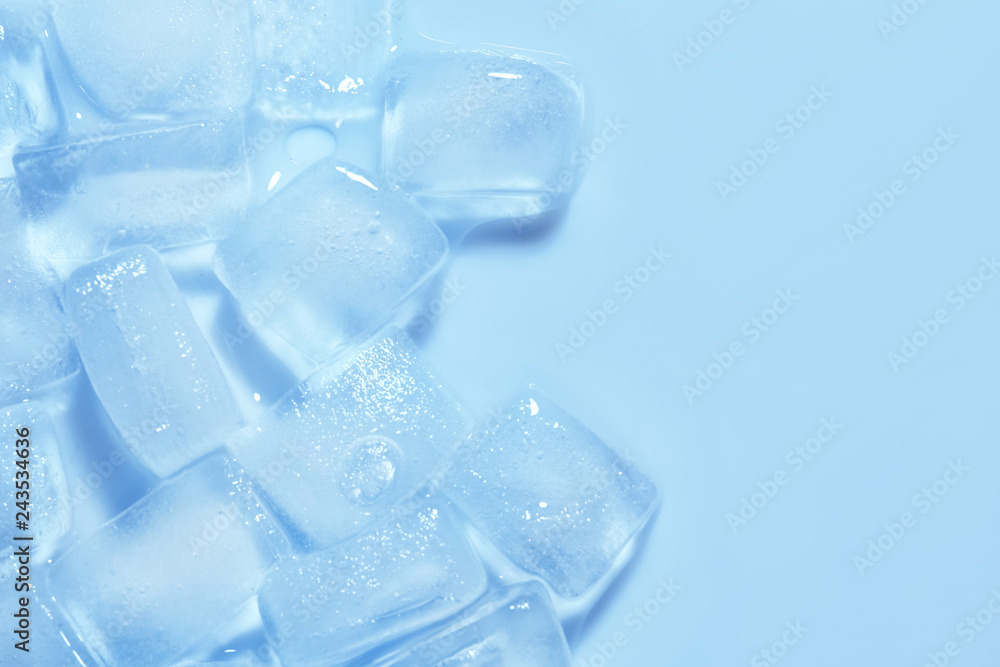 Melting ice cubes on color background, top view. Space for text Melting ice cubes on color background, top view. Space for text