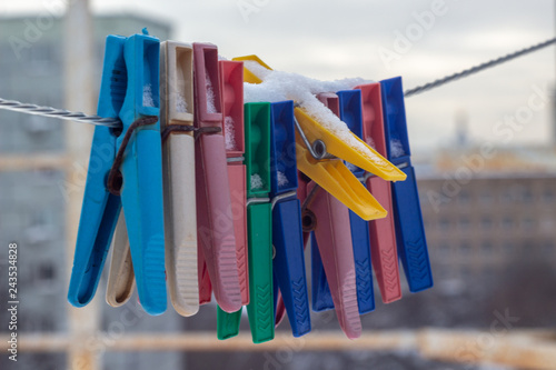 Snow-covered clothespins outside in winter