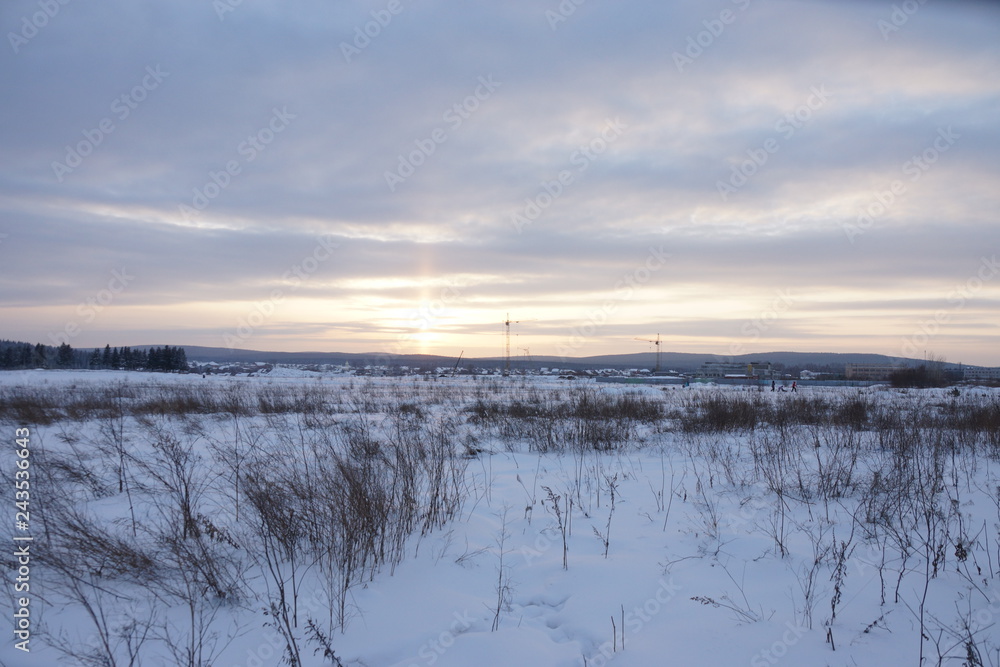 sunset on a snowy field