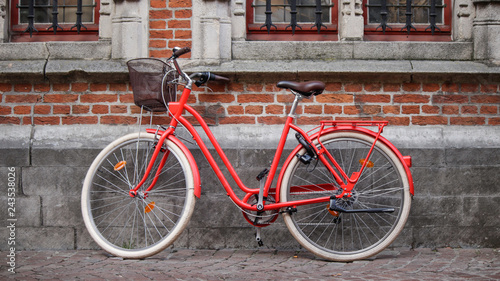 Red bicycle with bricks background