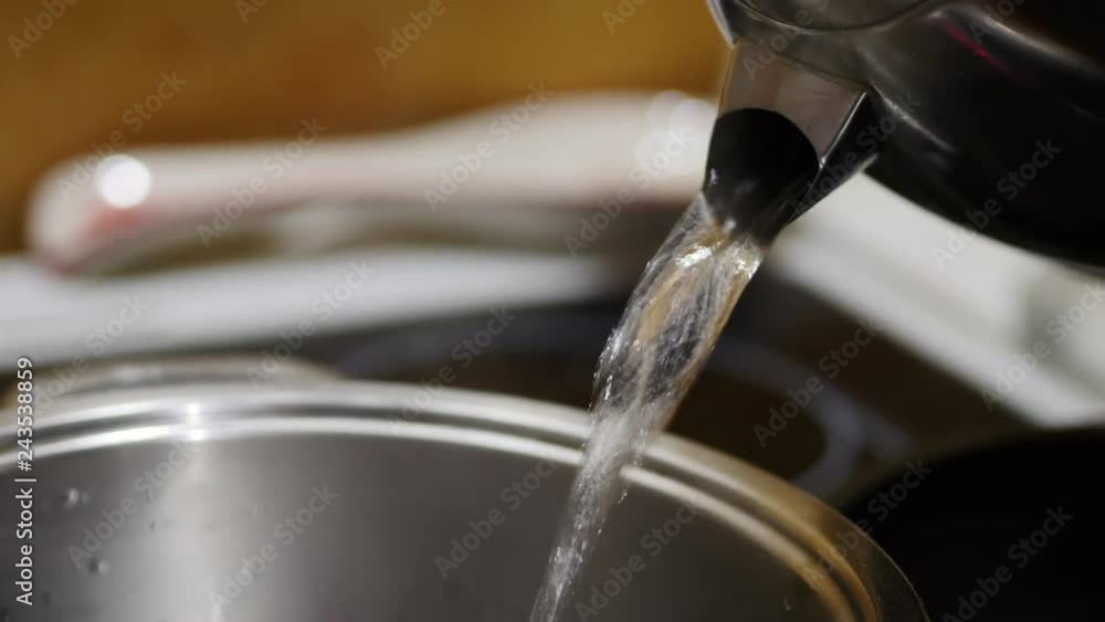Boiling Water From Kettle Into Pot Boiling Water From Kettle Into Pot