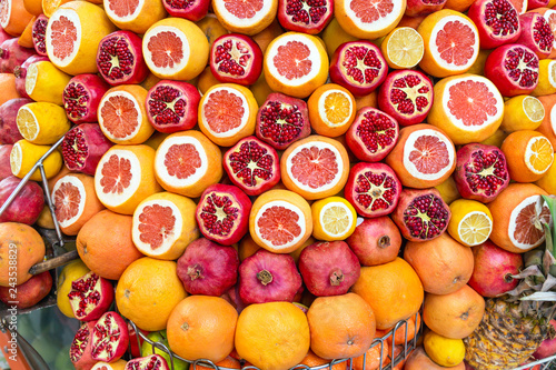 Ripe and juicy half peeled pomegranates  oranges ready to be squeezed for fresh juice. Istanbul  Turkey in summer.