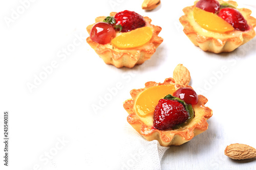 almond cake with berries on white background