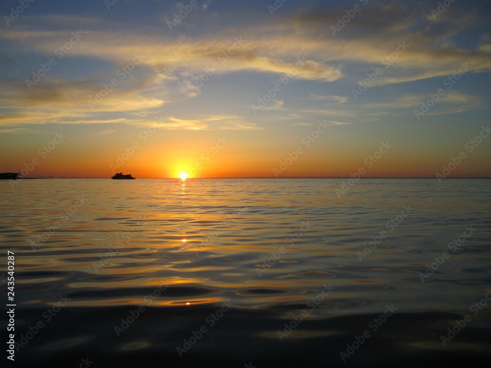The waves of the sea in the sunset
