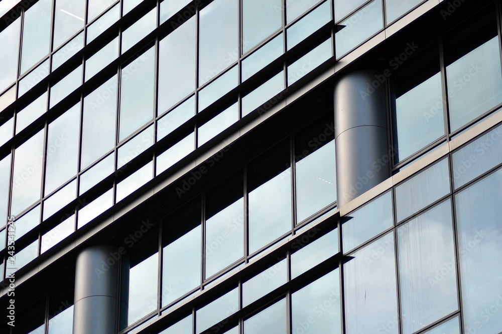 Modern building with reflected sky and cloud in glass window Modern building with reflected sky and cloud in glass window