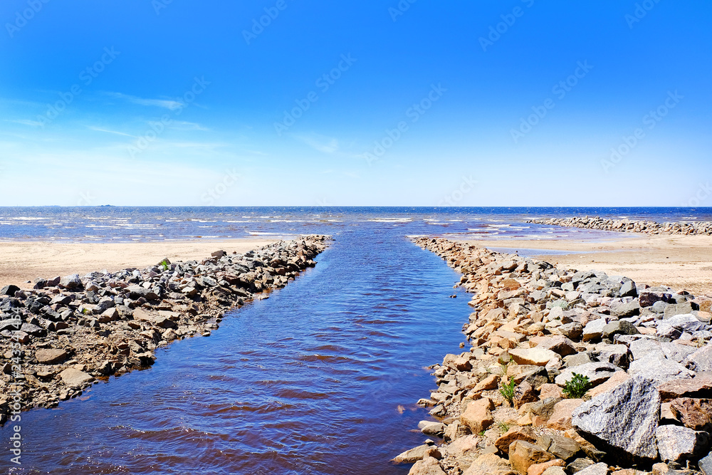 water channel, flowing into the sea, rocky beach. seascape. water channel, flowing into the sea, rocky beach. seascape.