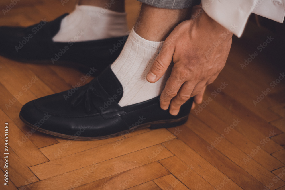 the groom sits on the wedding mornings