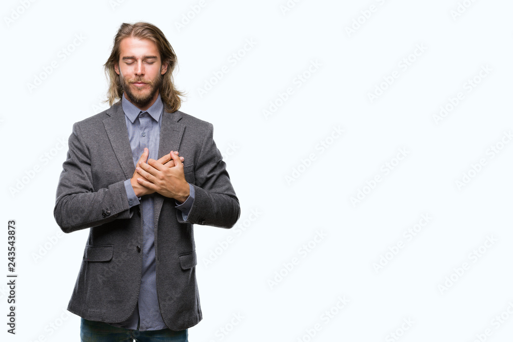 Young handsome business man with long hair over isolated background smiling with hands on chest with closed eyes and grateful gesture on face. Health concept. Young handsome business man with long hair over isolated background smiling with hands on chest with closed eyes and grateful gesture on face. Health concept.
