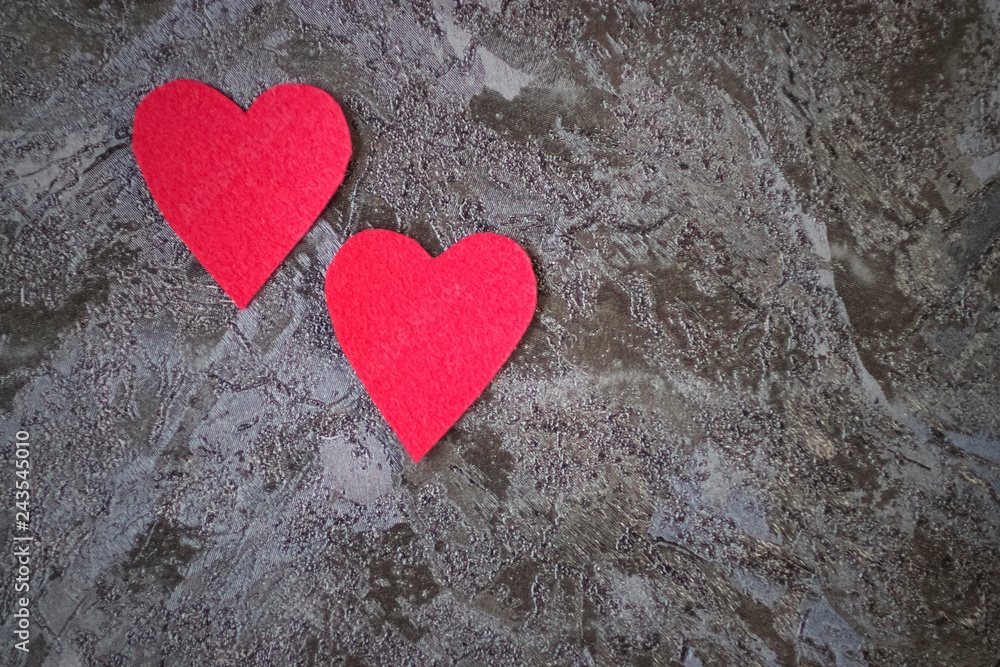 Two red decorative hearts on a black background. Valentine's Day Concept. Two red decorative hearts on a black background. Valentine's Day Concept.