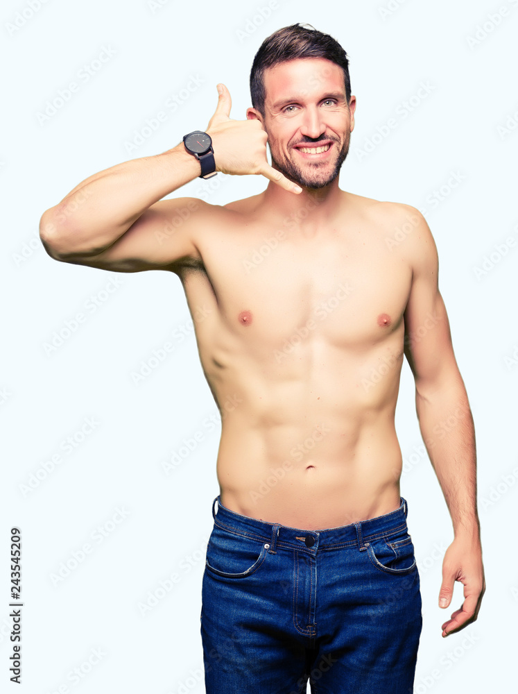 Handsome shirtless man showing nude chest smiling doing phone gesture with hand and fingers like talking on the telephone. Communicating concepts. Handsome shirtless man showing nude chest smiling doing phone gesture with hand and fingers like talking on the telephone. Communicating concepts.