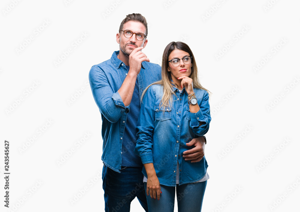 Young couple in love wearing glasses over isolated background with hand on chin thinking about question, pensive expression. Smiling with thoughtful face. Doubt concept.