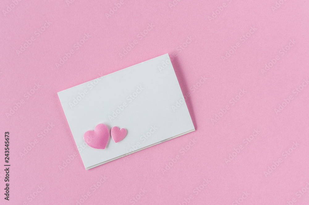 Paper card mockup on pink background with two hearts. Top view. Flat lay. Love confession