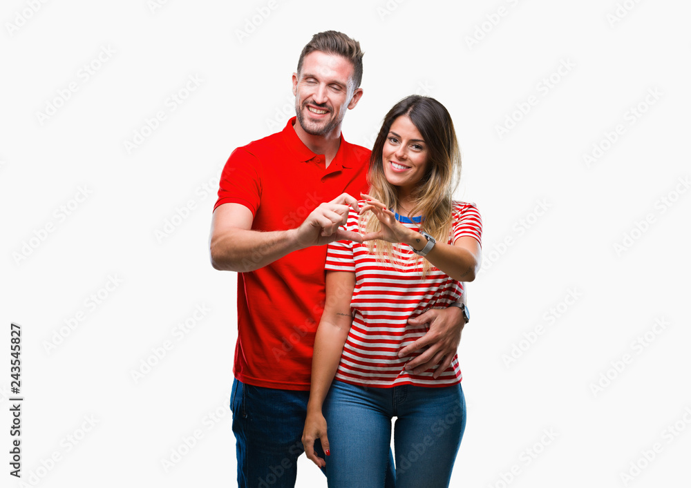 Young couple in love over isolated background smiling in love showing heart symbol and shape with hands. Romantic concept. Young couple in love over isolated background smiling in love showing heart symbol and shape with hands. Romantic concept.