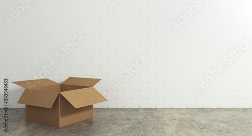 Empty open cardboard box on the floor with a wall background. Concept of moving and shipping
