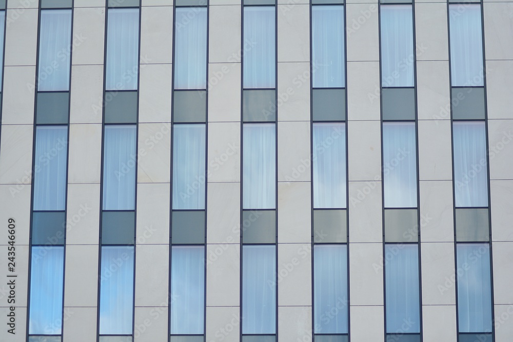 Modern building with reflected sky and cloud in glass window Modern building with reflected sky and cloud in glass window