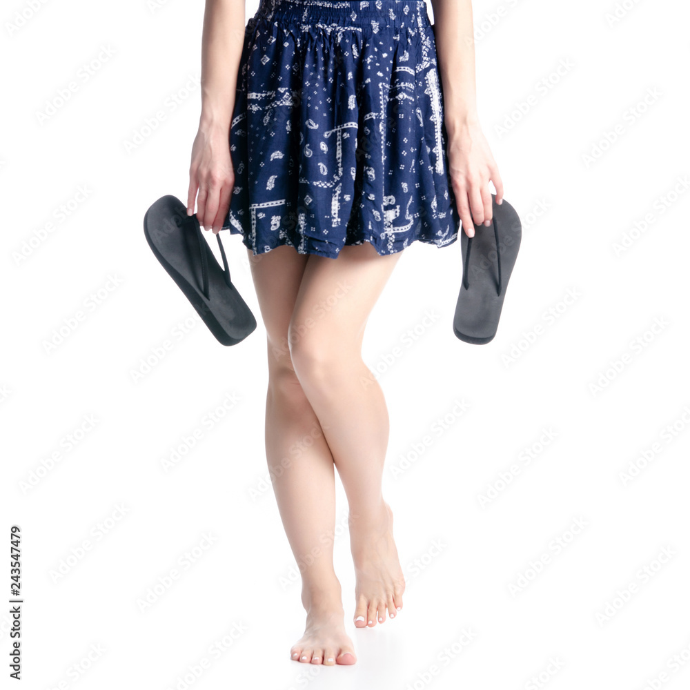 Woman legs in hands black flip flops  on white background isolation
