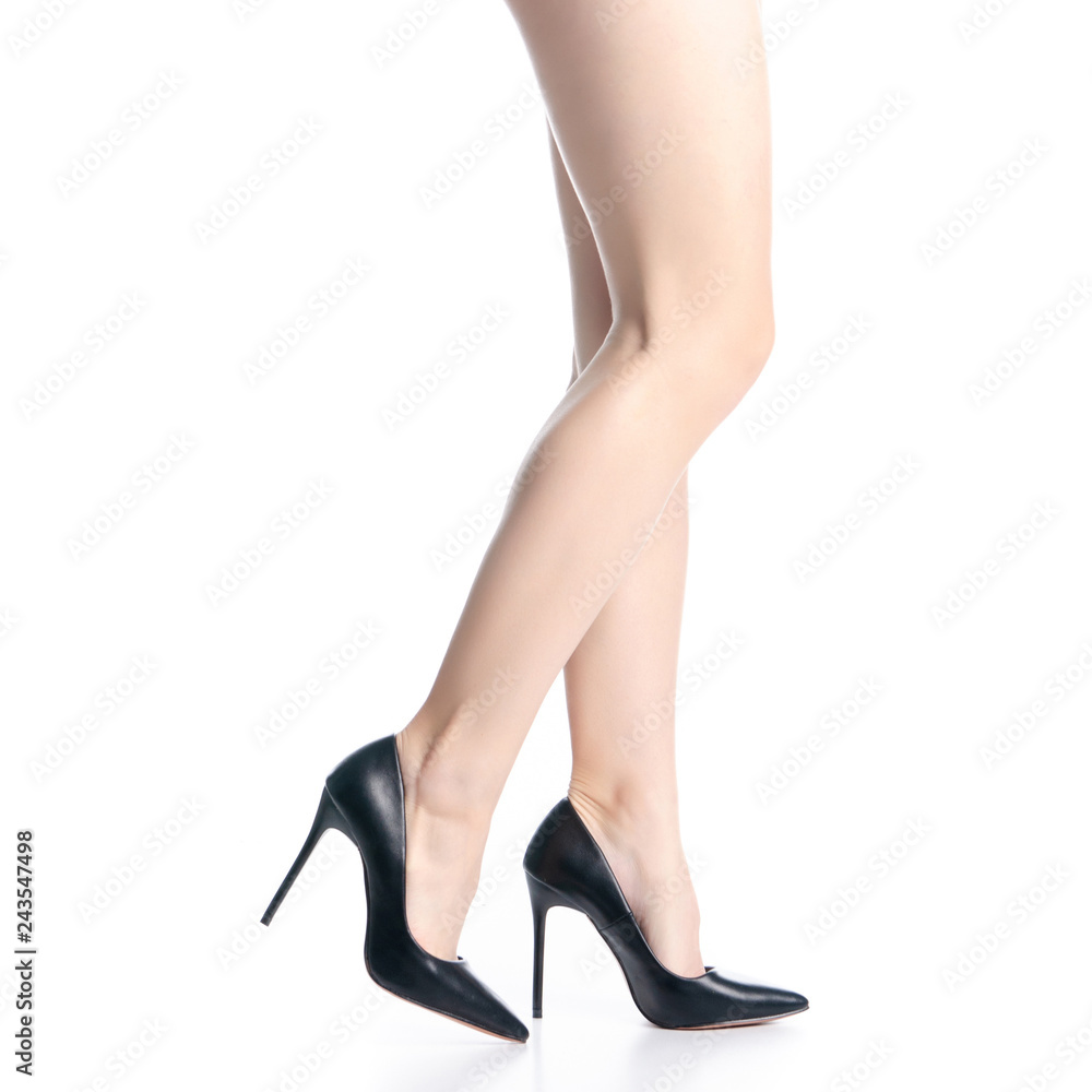 Female legs in black high heels shoes fashion goes on white background isolation Female legs in black high heels shoes fashion goes on white background isolation