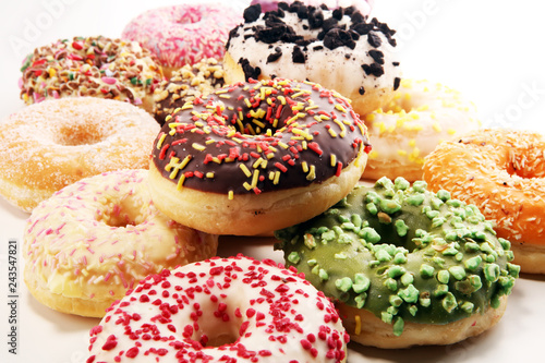 assorted donuts with chocolate frosted, pink glazed and sprinkles