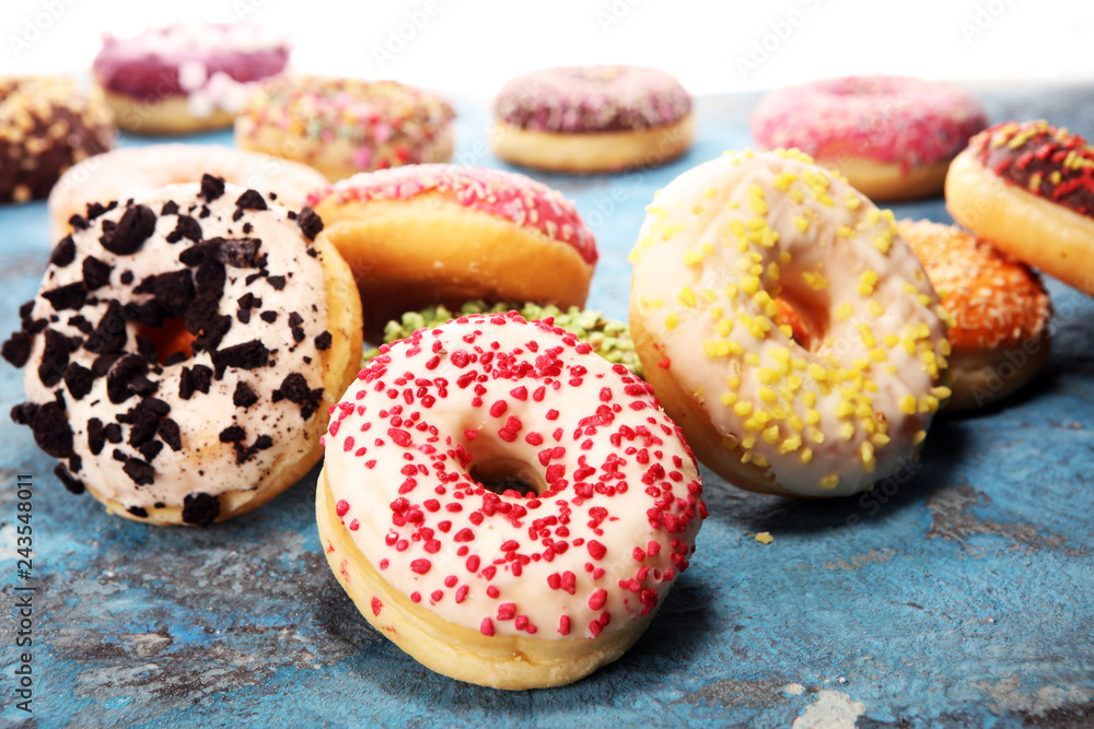 assorted donuts with chocolate frosted, pink glazed and sprinkles