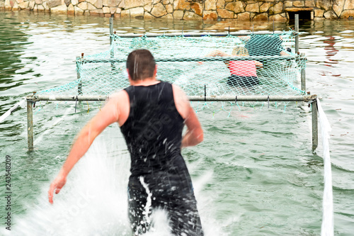 competitor runners in extreme obstacle course race photo