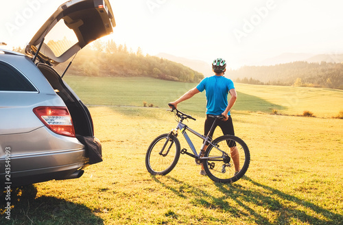 Man with bMan came by auto in mountain with his bicycle on the roof. Mountain biking concept image