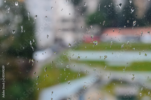 Water drops on window in rainy day © 0meer