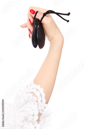 Woman's hand with castanets over white background photo