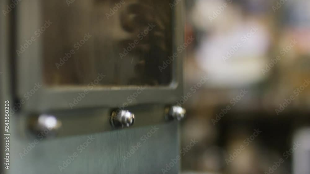 Close up of suction vent window as coffee beans pass through Close up of suction vent window as coffee beans pass through