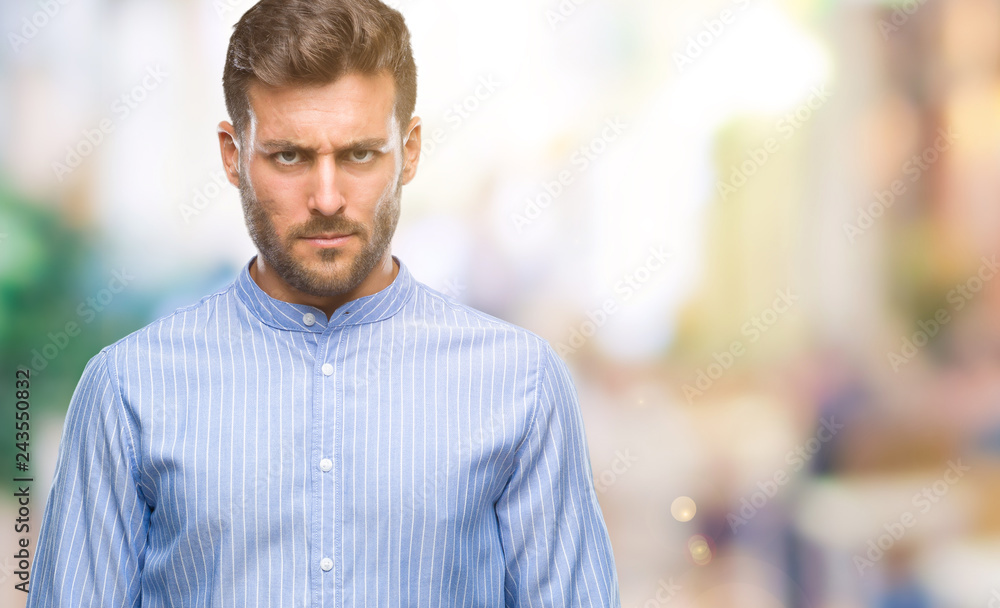 Young handsome man over isolated background skeptic and nervous, frowning upset because of problem. Negative person. Young handsome man over isolated background skeptic and nervous, frowning upset because of problem. Negative person.
