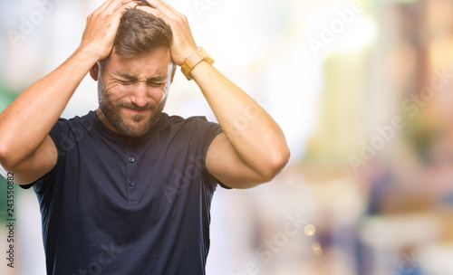 Young handsome man over isolated background suffering from headache desperate and stressed because pain and migraine. Hands on head.