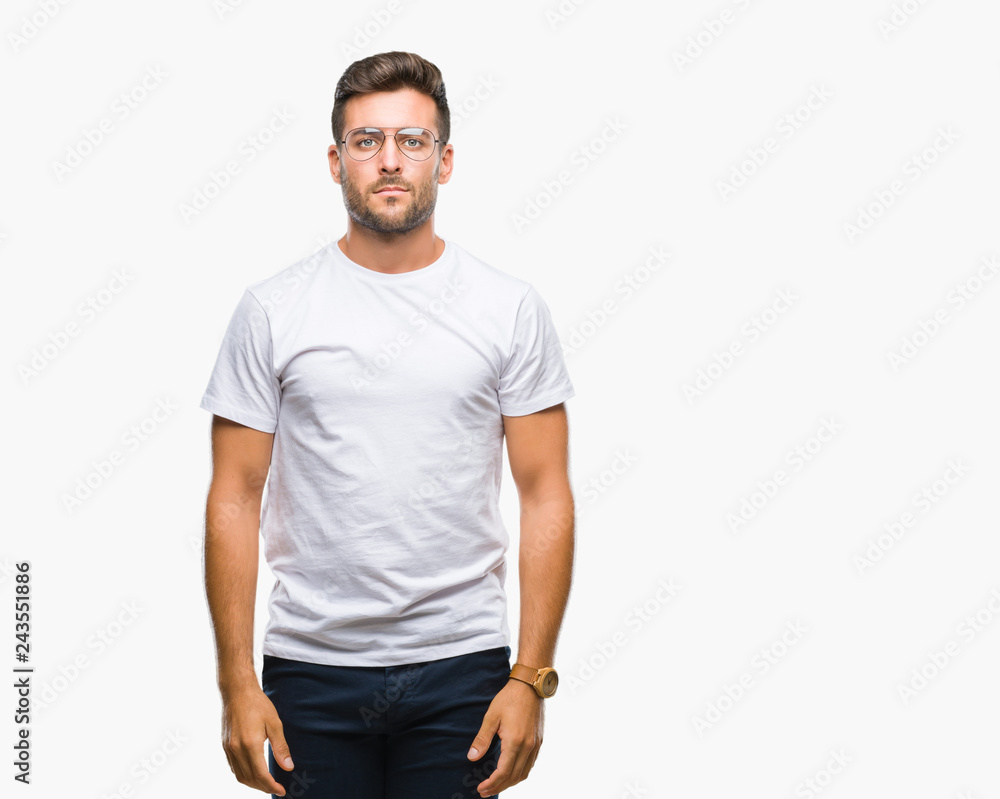 Young handsome man wearing glasses over isolated background with serious expression on face. Simple and natural looking at the camera. Young handsome man wearing glasses over isolated background with serious expression on face. Simple and natural looking at the camera.