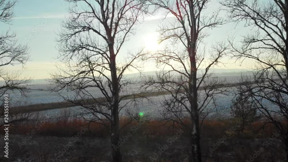 Driving through countryside in the gorgeous landscape on winter morning. Sunrise in beautiful large fields covered with snow. Roadtrip. Driving through countryside in the gorgeous landscape on winter morning. Sunrise in beautiful large fields covered with snow. Roadtrip.