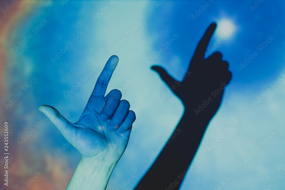 hand making the gesture of a gun on colorful background hand making the gesture of a gun on colorful background