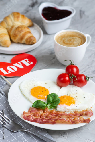 Tasty Fried Egg in the Shape of a Heart Served on a White Plate with Bacon Tomato Basil Pepper Gray Background Valentine Day Breakfast