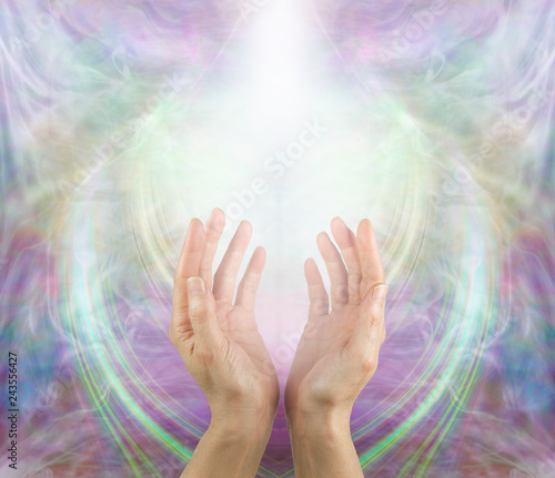 Ask Believe Receive in the Power of Love - female with hands reaching up into a white light against a beautiful angelic ethereal cup shaped background and copy space above
