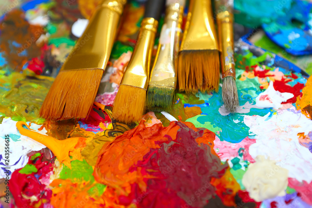 Fototapeta premium workplace painter palette with colors and brushes. Palette of colors, creative disorder, art.