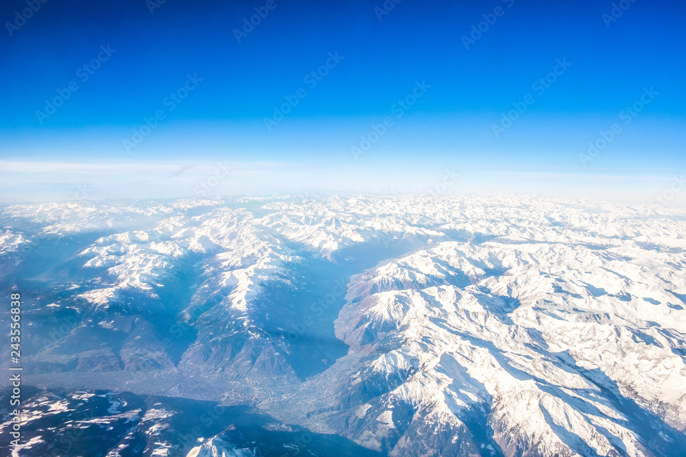 Snow Covered Alps Mountains Aerial view, Clear Blue Sky