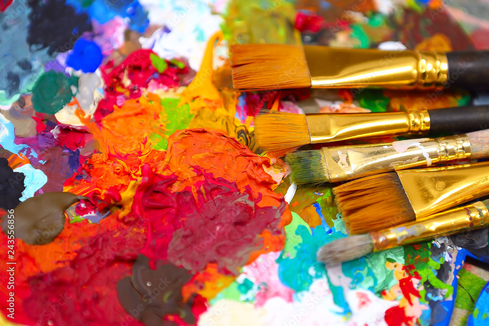 Obraz premium workplace painter palette with colors and brushes. Palette of colors, creative disorder, art.
